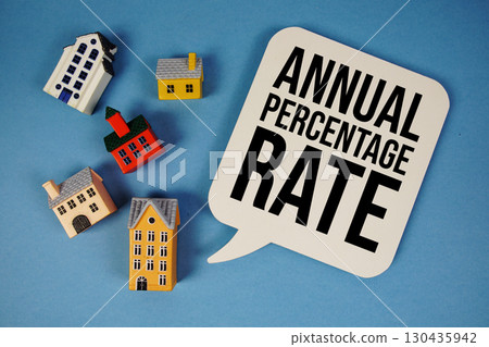 Adjustable Rate Mortgage text with house models on blue background Adjustable Rate Mortgage text with house models on blue background 130435942