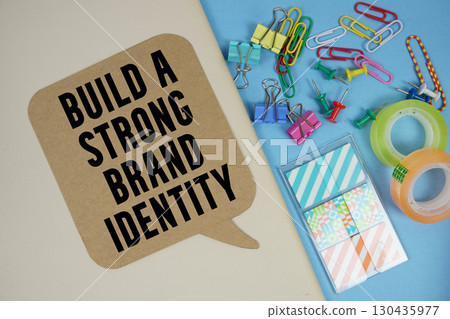 Build A Strong Brand Identity text with stationery on cover notebook background 130435977