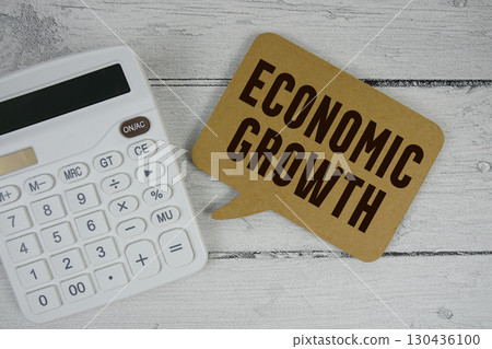 Economic Growth text with calculator on wooden background Economic Growth text with calculator on wooden background 130436100