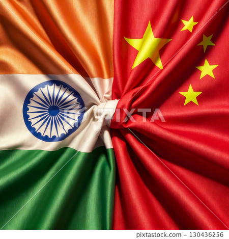 flags of china and india tied in a knot and lying next to each other, top view 130436256