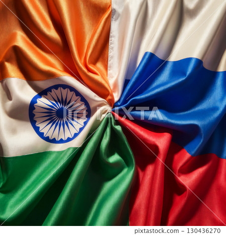 flags of russia and india tied in a knot and lying next to each other, top view 130436270