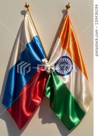 tied indian and russian flags hanging on white wall, close up 130436284