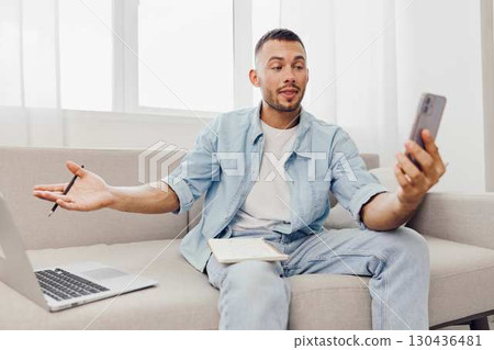 Engaged man communicating on phone, expressing emotions. Balancing work-life while navigating modern challenges of technology and mental health. Engaged man communicating on phone, expressing emotions. Balancing work-life while navigating modern challenges of technology and mental health. 130436481