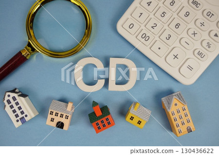 CD abbreviation of Closing Disclosure alphabet letters with house model, magnifying glass and calculator on blue background CD abbreviation of Closing Disclosure alphabet letters with house model, magnifying glass and calculator on blue background 130436622