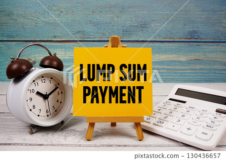 Lump Sum Payment text written on paper card with calculator and alarm clock on wooden background Lump Sum Payment text written on paper card with calculator and alarm clock on wooden background 130436657