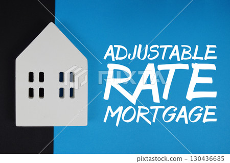 ARM Adjustable Rate Mortgage text with house models on blue background 130436685