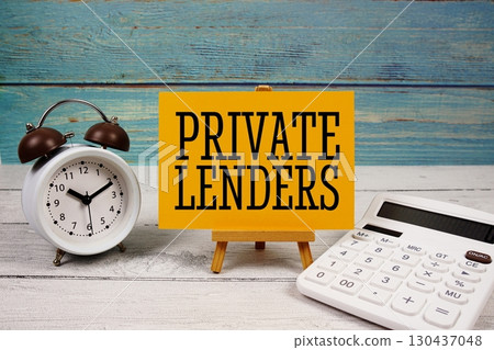 Private Lenders text written on paper card with calculator and alarm clock on wooden background 130437048