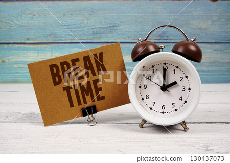 Break Time text written on paper card with alarm clock on wooden background 130437073
