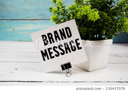 Brand Message text written on paper card on wooden background Brand Message text written on paper card on wooden background 130437079