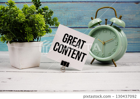 Great Content text written on paper card with alarm clock on wooden background 130437092