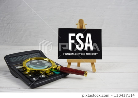 FSA abbreviation of Financial Services Authority text with magnifying glass and calculator on wooden background FSA abbreviation of Financial Services Authority text with magnifying glass and calculator on wooden background 130437114