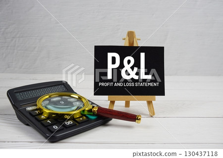 P and L abbreviation of Profit And Loss text with magnifying glass and calculator on wooden background P and L abbreviation of Profit And Loss text with magnifying glass and calculator on wooden background 130437118