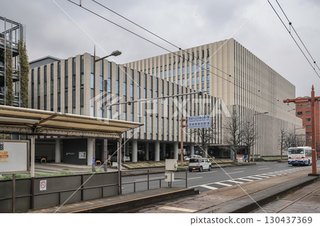 March 28 2025 Office Building, Street With Vehicles on Overcast Day, Japan March 28 2025 Office Building, Street With Vehicles on Overcast Day, Japan 130437369