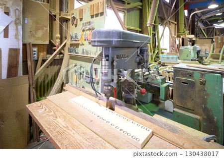An electric drill press installed in a woodworking shop An electric drill press installed in a woodworking shop 130438017