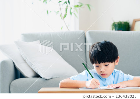 Elementary school boy studying in the living room Elementary school boy studying in the living room 130438023