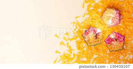Diwali Festival. Colorful diyas scattered among marigold petals. 130438107