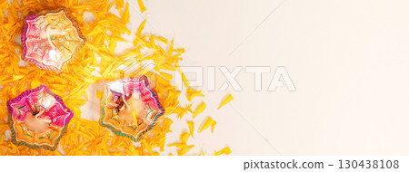 Diwali Festival Decor. Colorful rangoli with marigold flowers and decorative lamps. 130438108