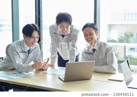 A man in work clothes having a meeting A man in work clothes having a meeting 130438511