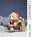 Teddy bear with Santa hat sitting on a Christmas sleigh 130439873