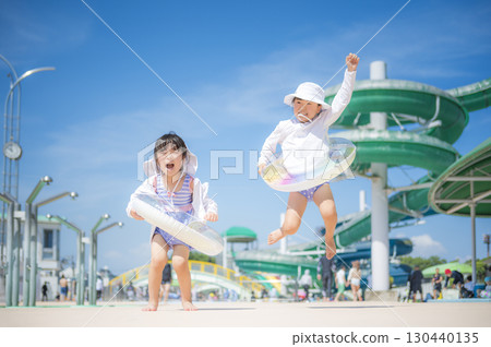 Children playing in the pool under the blue sky 130440135