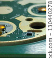 Macro view of green electronic circuit board showing intricate technology. Computer hardware component with microchip detail on pcb board. sense of complex innovation 130440278