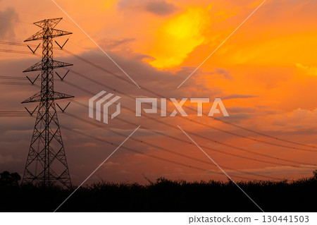 Electricity Power line, High voltage power transmission tower to urban against twilight sky. 130441503
