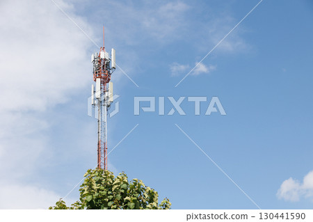 Communication towers on blue sky, 5G networks post. Network cell site. Omni direction data link Communication towers on blue sky, 5G networks post. Network cell site. Omni direction data link 130441590