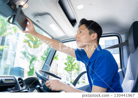 Male driver driving a truck Male driver driving a truck 130441967