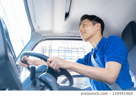 Male driver driving a truck 130441968