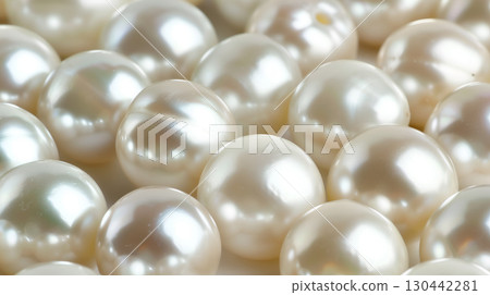 Soft, gleaming pearls scattered across a textured surface create a serene and elegant visual 130442281