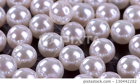 Beautiful arrangement of lustrous pearls on a dark surface creating an elegant background 130442282
