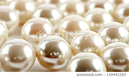 Close-up view of lustrous pearls scattered on a soft background evoking elegance and luxury 130442283