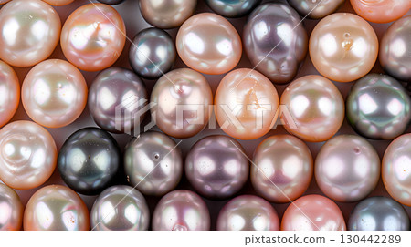 Beautiful collection of various colored pearls on a smooth surface showcasing their natural luster 130442289