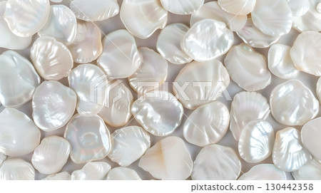 A close-up view of beautiful pearl shell pieces on a soft background displaying their luster A close-up view of beautiful pearl shell pieces on a soft background displaying their luster 130442358