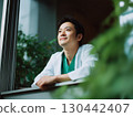 A male doctor looking up at the sky from the window 130442407