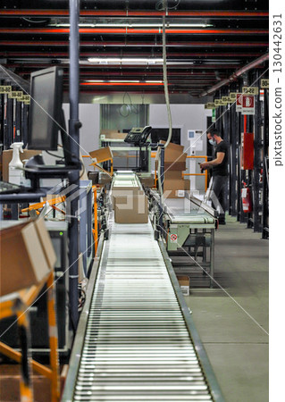logistic warehouse. packing line in a logistics warehouse. conveyor belt in a modern production line 130442631