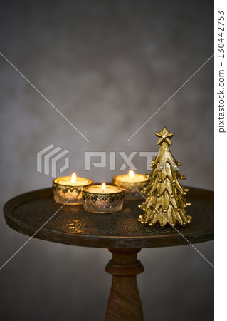 Christmas tree and candles on an antique side table Christmas tree and candles on an antique side table 130442753