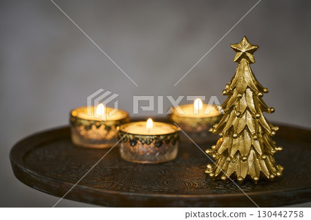 Christmas tree and candles on an antique side table Christmas tree and candles on an antique side table 130442758