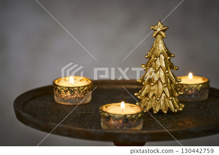 Christmas tree and candles on an antique side table Christmas tree and candles on an antique side table 130442759