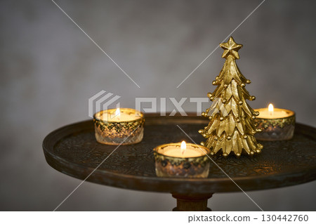 Christmas tree and candles on an antique side table Christmas tree and candles on an antique side table 130442760