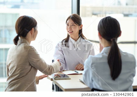 Women shaking hands: medical and sales professionals 130442901