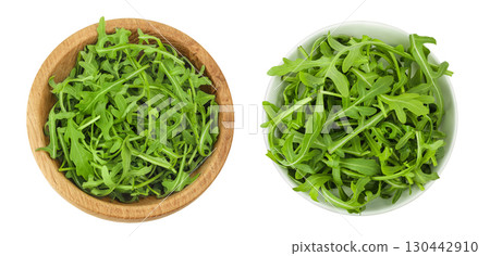 Heap of green fresh rucola or arugula leaf in wooden and ceramic bowl isolated on white background. Top view, flat lay 130442910