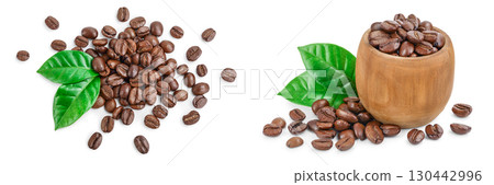 Heap of roasted coffee beans with leaves isolated on white background . Top view. Flat lay. Heap of roasted coffee beans with leaves isolated on white background . Top view. Flat lay. 130442996
