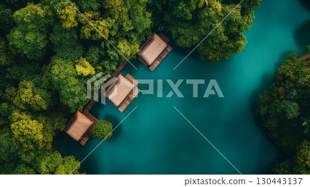 Aerial view of serene turquoise waters surrounded by lush greenery. Rustic wooden cabins sit peacefully on the water. Discover natural tranquility. Generative AI 130443137