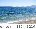 Seascape with the mountains in the background. Sea waves on the beach. Sea, sky and the beach. 130443216