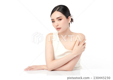 A beautiful young Asian woman with clean, fresh skin against a white background. Skincare, facial treatment, cosmetology, beauty, and spa. An elegant portrait of an Asian woman. A beautiful young Asian woman with clean, fresh skin against a white background. Skincare, facial treatment, cosmetology, beauty, and spa. An elegant portrait of an Asian woman. 130443230