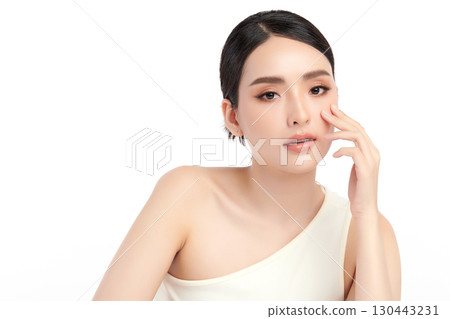 A beautiful young Asian woman with clean, fresh skin against a white background. Skincare, facial treatment, cosmetology, beauty, and spa. An elegant portrait of an Asian woman. A beautiful young Asian woman with clean, fresh skin against a white background. Skincare, facial treatment, cosmetology, beauty, and spa. An elegant portrait of an Asian woman. 130443231