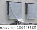 A sunshade hung on a window to protect from the afternoon sun 130443385