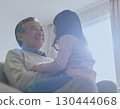 Happy grandfather with grandson on his lap 130444068