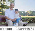 Happy grandfather with grandson on his lap 130444071